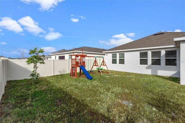 view of playground with a lawn