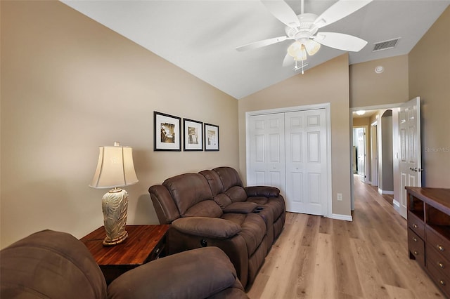 living room featuring ceiling fan, high vaulted ceiling, and light hardwood / wood-style flooring