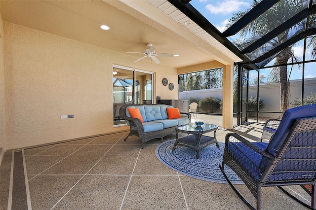 view of patio with outdoor lounge area, ceiling fan, and glass enclosure