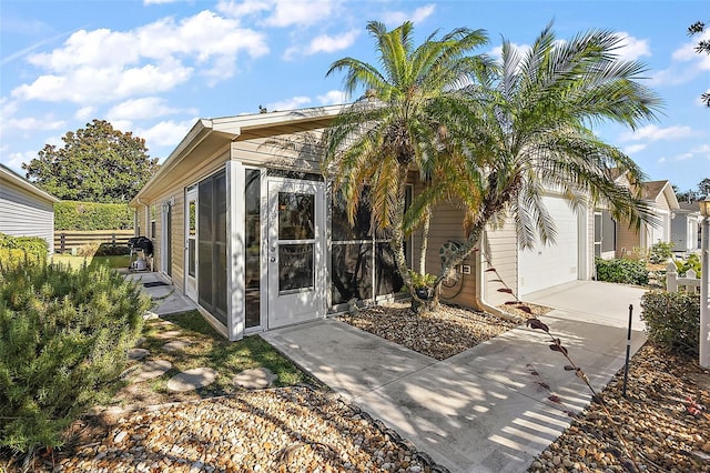 view of property exterior featuring a sunroom