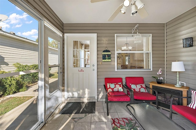 sunroom featuring ceiling fan