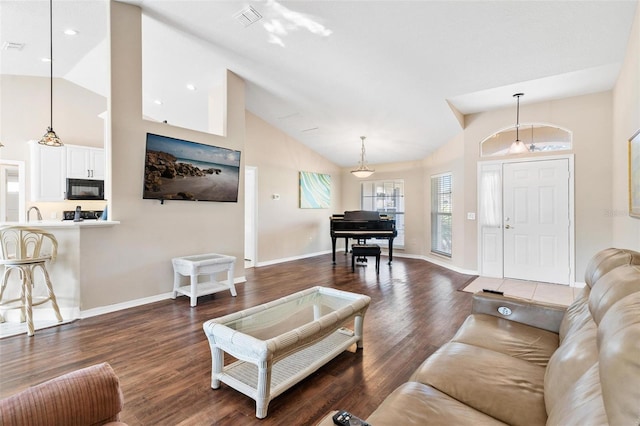 living room featuring high vaulted ceiling and dark hardwood / wood-style floors