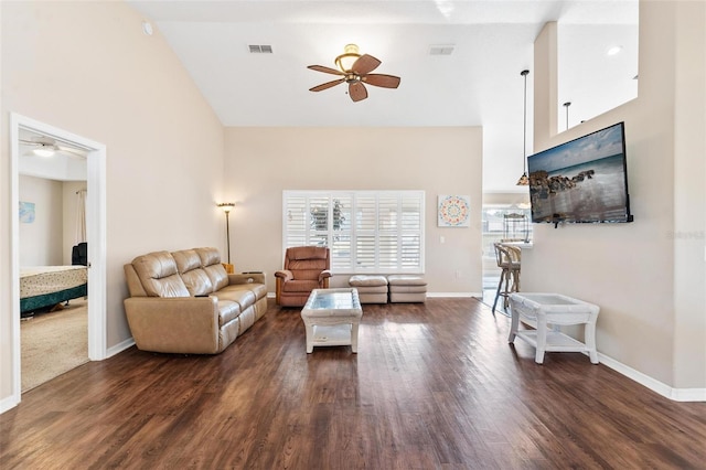 living room featuring ceiling fan, dark hardwood / wood-style flooring, and high vaulted ceiling