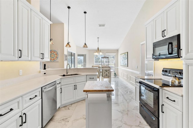 kitchen with an inviting chandelier, black appliances, sink, decorative light fixtures, and white cabinetry