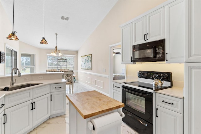 kitchen with white cabinets, sink, vaulted ceiling, and black appliances