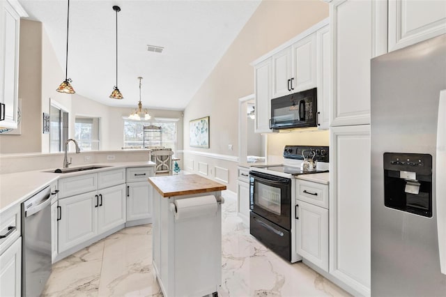 kitchen with lofted ceiling, black appliances, white cabinets, sink, and hanging light fixtures