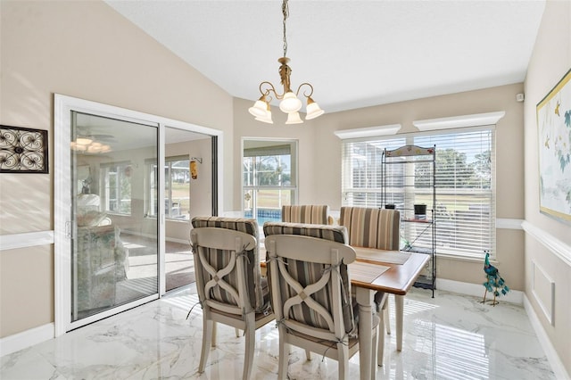 dining space featuring plenty of natural light, lofted ceiling, and a chandelier