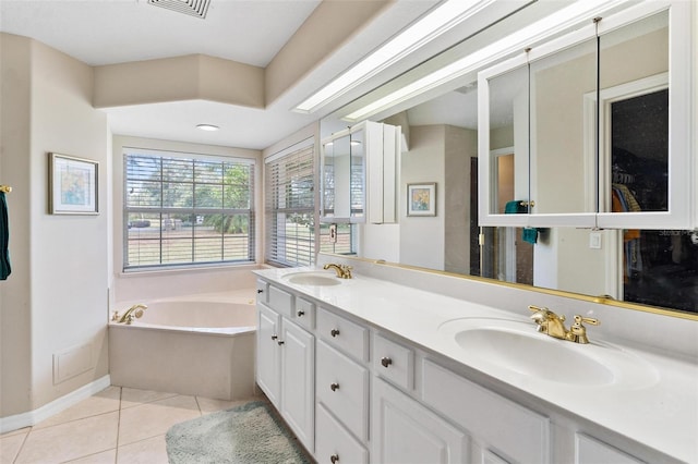 bathroom with tile patterned floors, vanity, and a bath