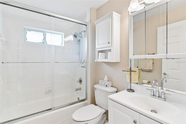 full bathroom with vanity, toilet, and bath / shower combo with glass door