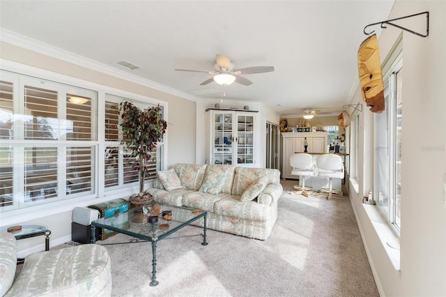 living room featuring light carpet, ceiling fan, and ornamental molding