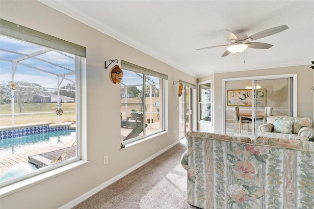 interior space with crown molding, ceiling fan, and light colored carpet