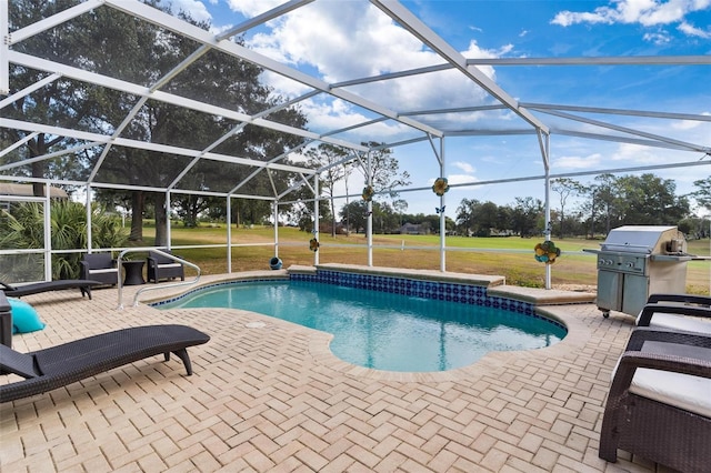 view of pool featuring a lanai, a patio area, a yard, and area for grilling