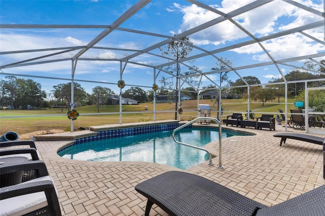 view of swimming pool with glass enclosure and a patio