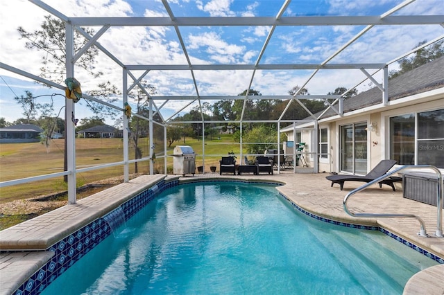 view of pool featuring glass enclosure, area for grilling, and a patio