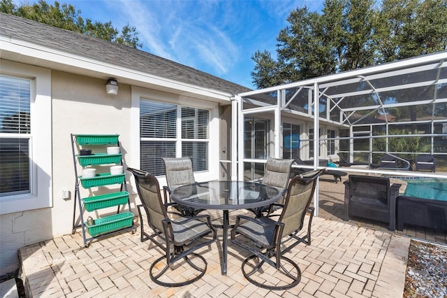 view of patio / terrace featuring glass enclosure