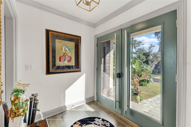 entryway with crown molding, french doors, and light hardwood / wood-style floors