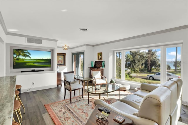 living room with dark hardwood / wood-style flooring and ornamental molding