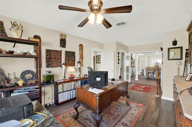 office space featuring dark hardwood / wood-style flooring and ceiling fan