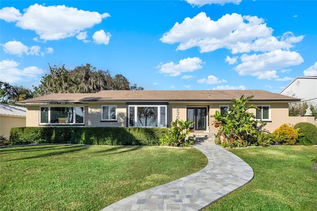 ranch-style home with a front lawn