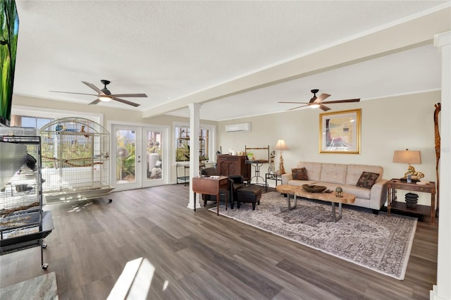 living room with ornate columns, ceiling fan, dark hardwood / wood-style flooring, and french doors