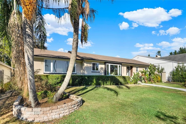 single story home featuring a front lawn