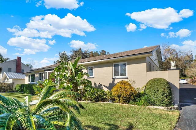 view of home's exterior featuring a lawn