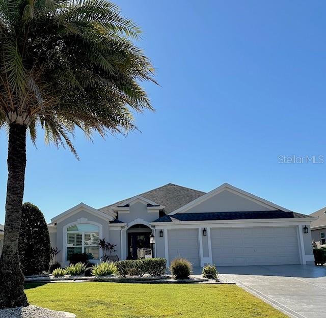 ranch-style home with a front lawn and a garage