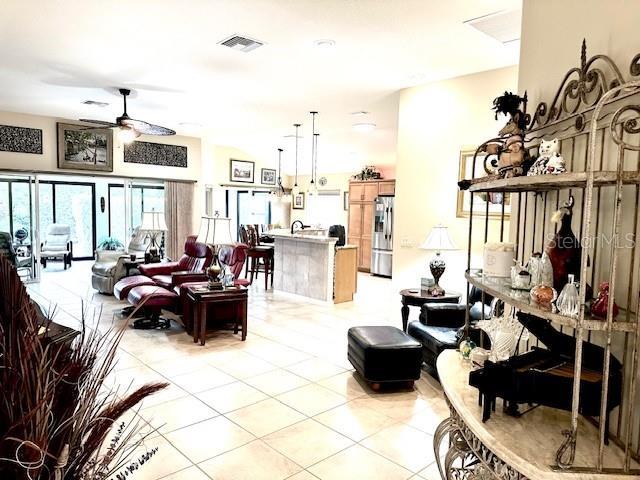 living room featuring light tile patterned floors and ceiling fan