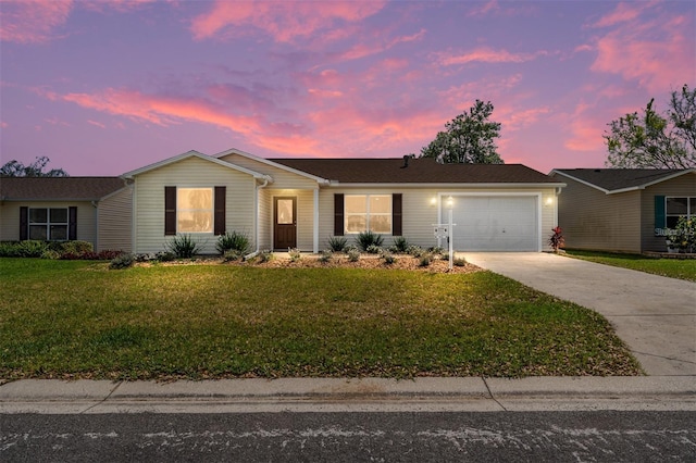 ranch-style home with a garage and a lawn