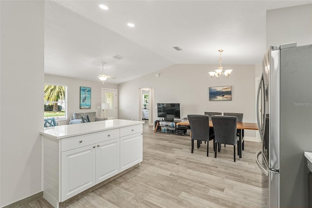 kitchen with stainless steel fridge, light wood-type flooring, decorative light fixtures, a chandelier, and white cabinetry