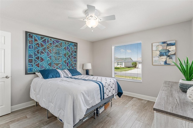 bedroom with hardwood / wood-style flooring and ceiling fan