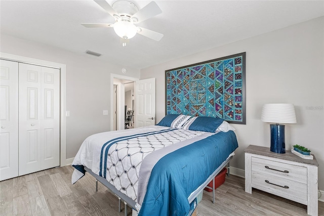 bedroom featuring wood-type flooring, a closet, and ceiling fan