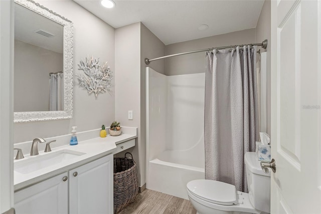 full bathroom with shower / bath combination with curtain, vanity, wood-type flooring, and toilet