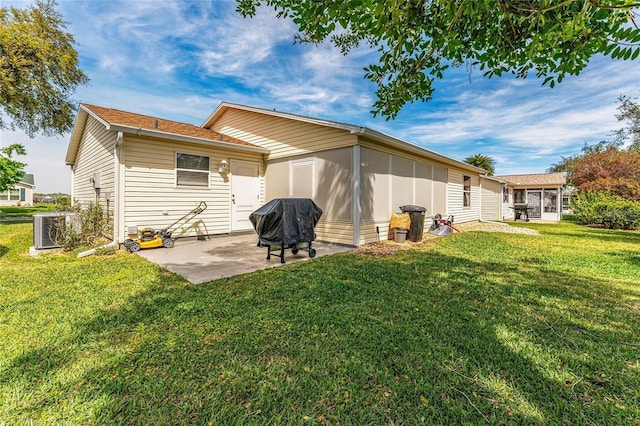 rear view of house with central air condition unit, a yard, and a patio