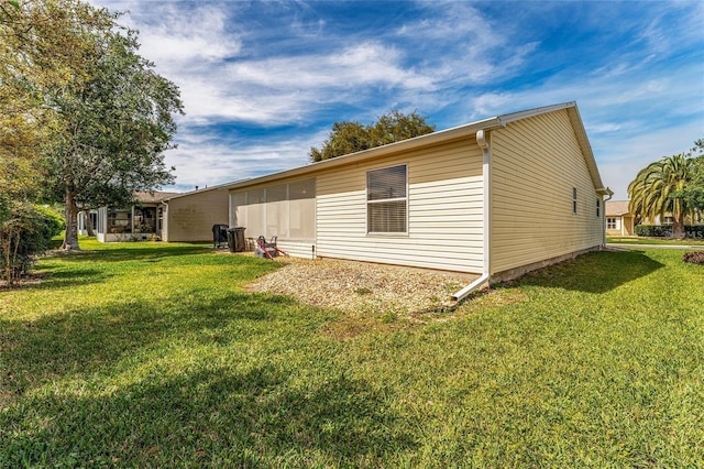 view of side of home featuring a lawn