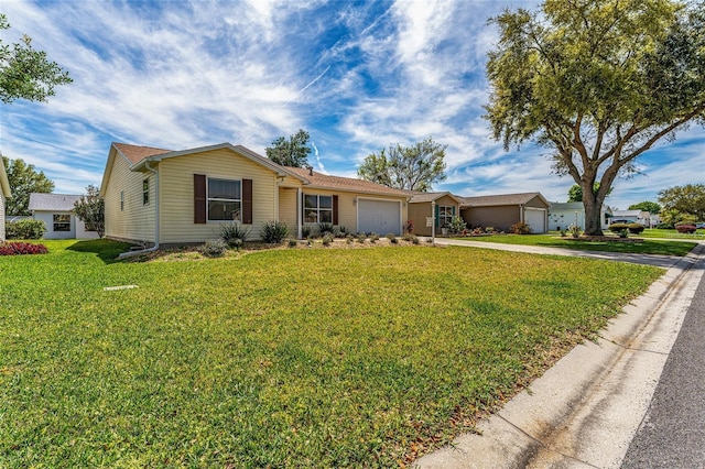 ranch-style house featuring a front yard and a garage