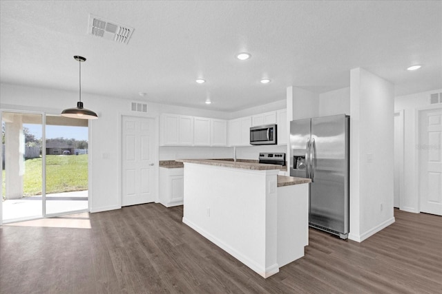 kitchen featuring white cabinetry, hanging light fixtures, stainless steel appliances, dark hardwood / wood-style floors, and a center island