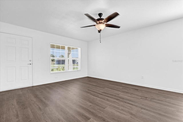 spare room featuring ceiling fan and dark hardwood / wood-style floors