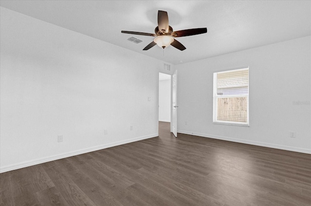 empty room with dark hardwood / wood-style flooring and ceiling fan