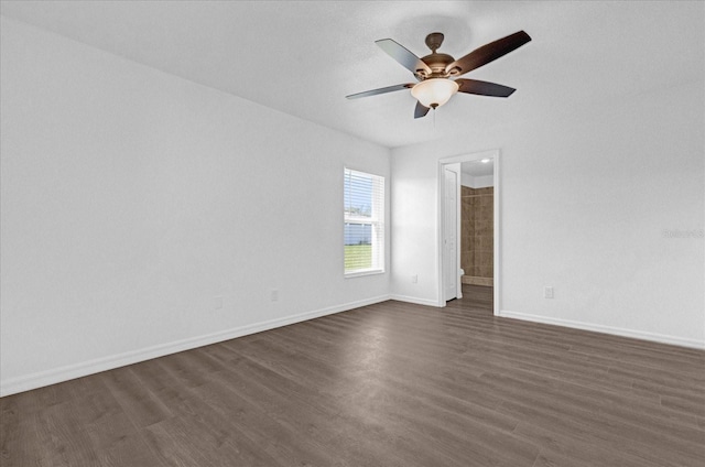 empty room with dark wood-type flooring and ceiling fan