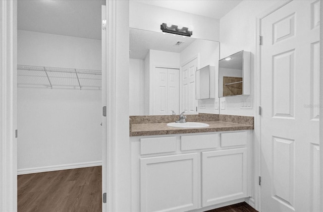 bathroom with vanity and hardwood / wood-style flooring