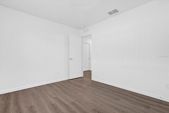 spare room featuring dark wood-type flooring