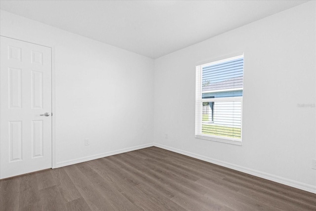 empty room featuring dark wood-type flooring