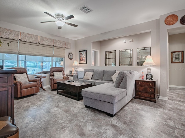 living room featuring a textured ceiling and ceiling fan