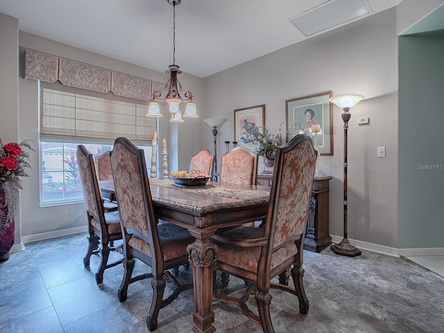 dining space with an inviting chandelier