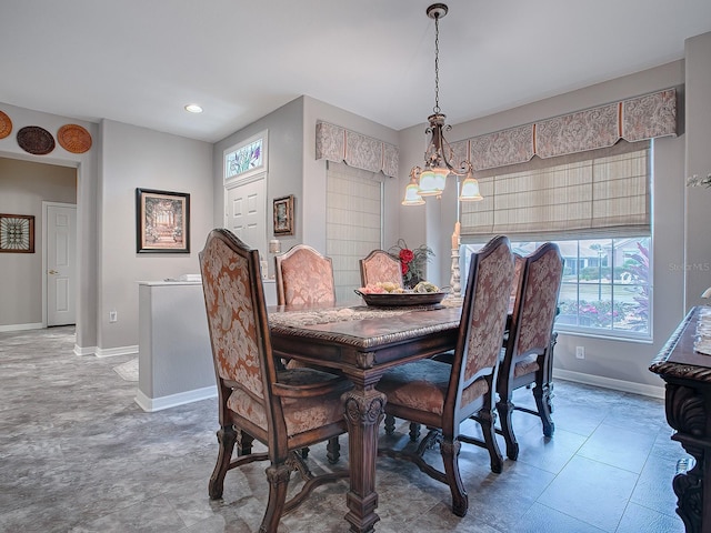 dining room featuring tile patterned flooring and a notable chandelier