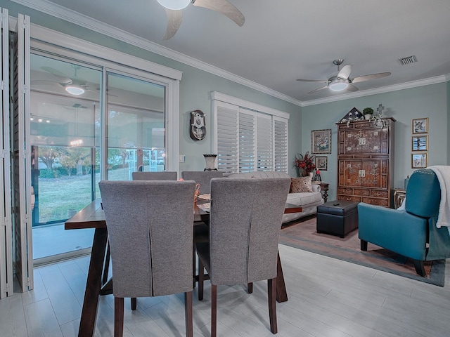 dining area featuring crown molding, ceiling fan, and light wood-type flooring