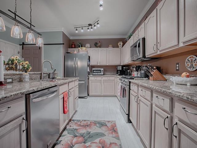 kitchen featuring appliances with stainless steel finishes, light stone counters, ornamental molding, and sink