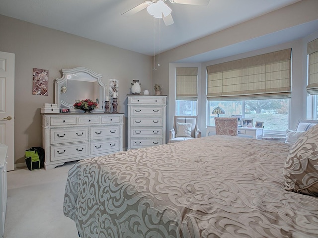 bedroom featuring light carpet and ceiling fan