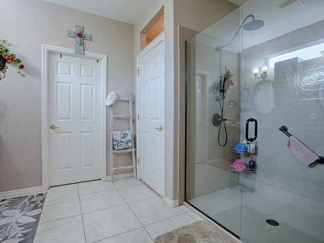 bathroom with tile patterned flooring and a shower with door